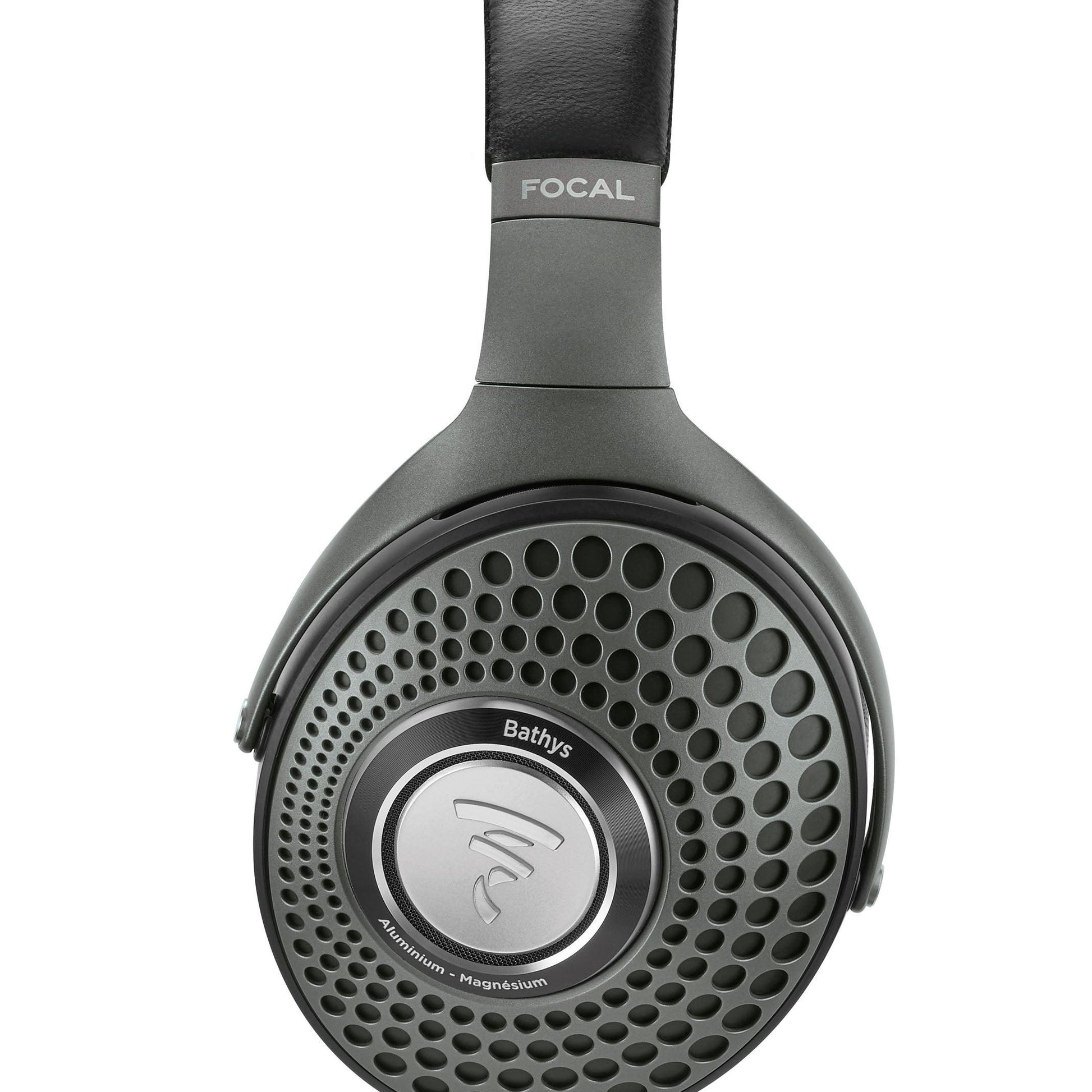 A close-up of the Focal Bathys headphones highlights their black ear cup with a circular grille design and the Focal logo centered.