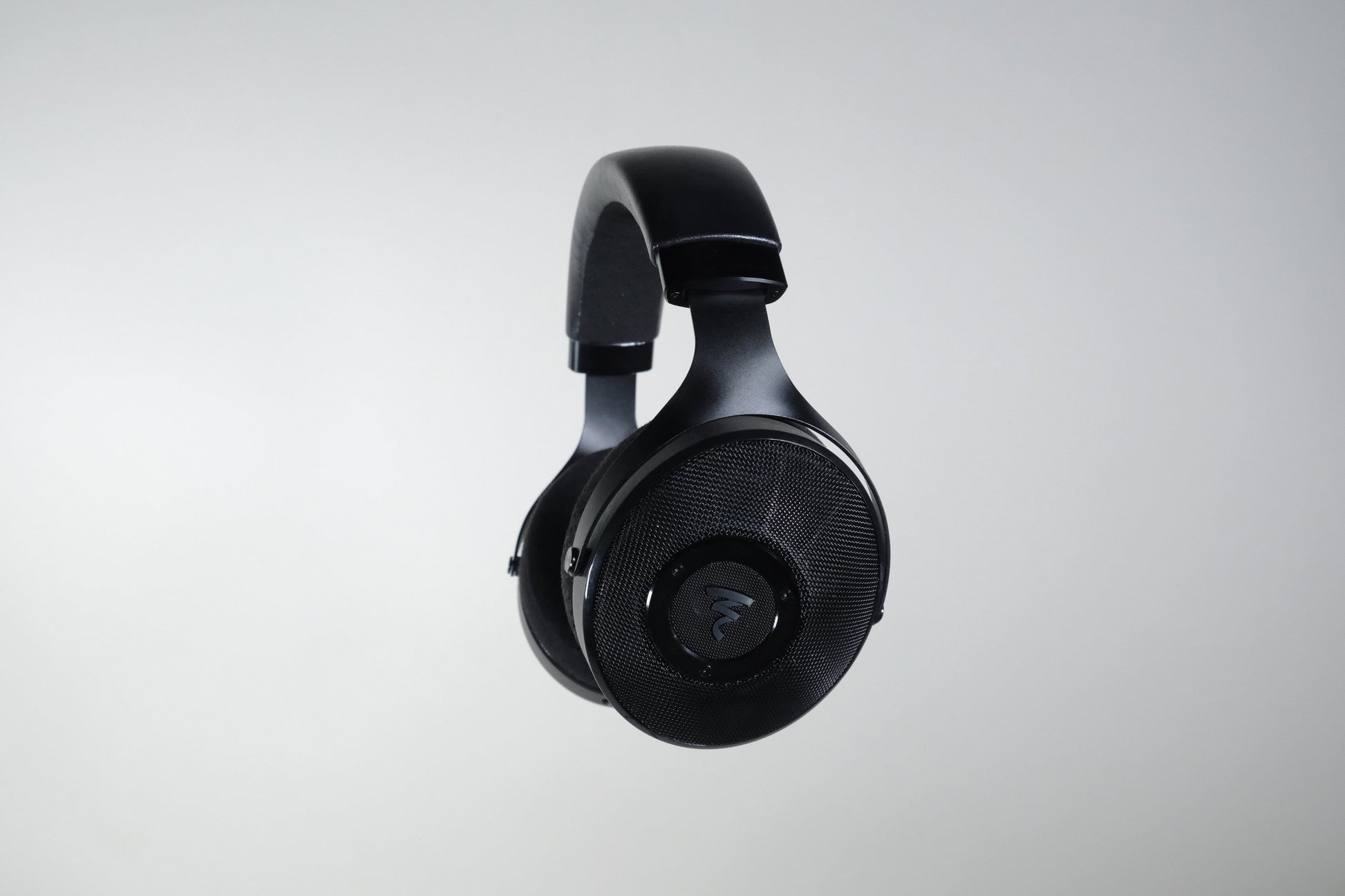 A pair of Focal Elex Headphones by Focal is displayed centered against a light gray background, showcasing the ear cups and headband in clear detail, exemplifying sonic perfection.