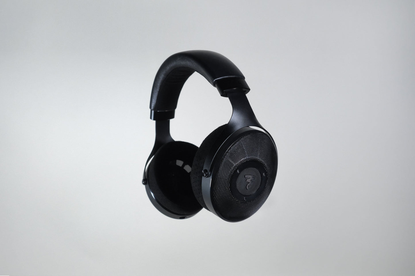 The Focal Elex Headphones by Focal, featuring a padded headband and mesh ear cups in black, are displayed against a plain light gray background, offering exceptional audio quality.