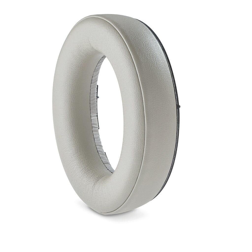 A single, light gray Focal Bathys headphone ear cushion by Focal is displayed vertically on a white background, highlighting its round shape and central opening—ideal for active noise-canceling headphones.