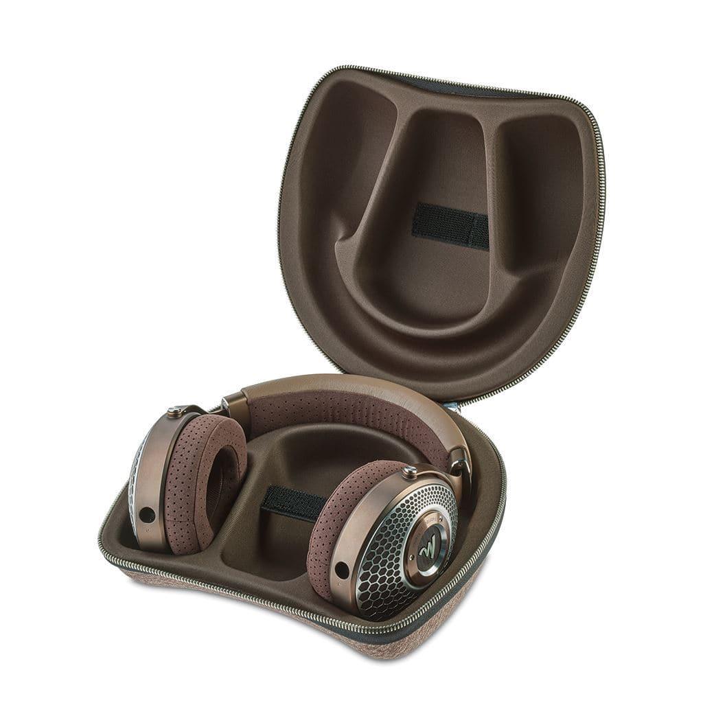 A pair of brown Focal Clear Mg Headphones by Focal sits in a matching open molded carrying case with metallic accents, revealing the neatly tailored interior.