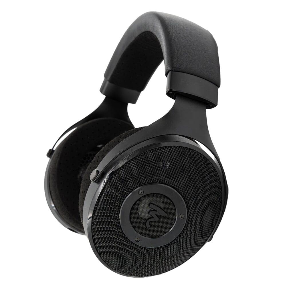 Focal Elex Headphones by Focal are black over-ear headphones with padded headband, round mesh ear cups, and a central circular logo, delivering sonic perfection. Shown against a white background.