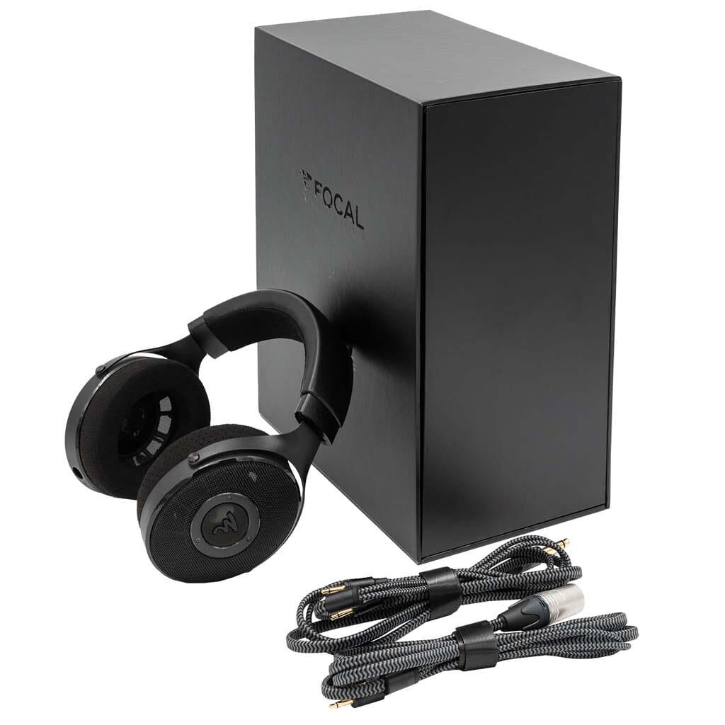 A pair of black Focal Elex Headphones by Focal rests beside a large black box, with two braided audio cables in front, each featuring gold-plated connectors for optimal sound quality.