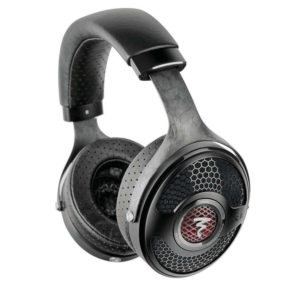 The Focal Utopia 2022 are black over-ear headphones with a padded headband, perforated ear cushions, and open-back honeycomb ear cups with a red-accented circular logo, delivering outstanding flagship sound quality.