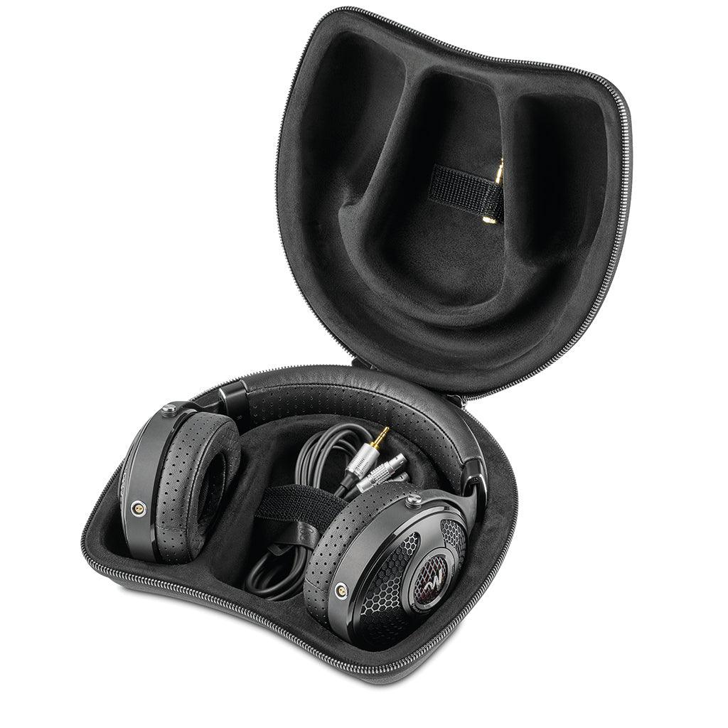 A pair of Focal Utopia 2022 black over-ear headphones with perforated pads rests in an open, zippered hard-shell case, cable coiled inside—highlighting their flagship sound quality and design.