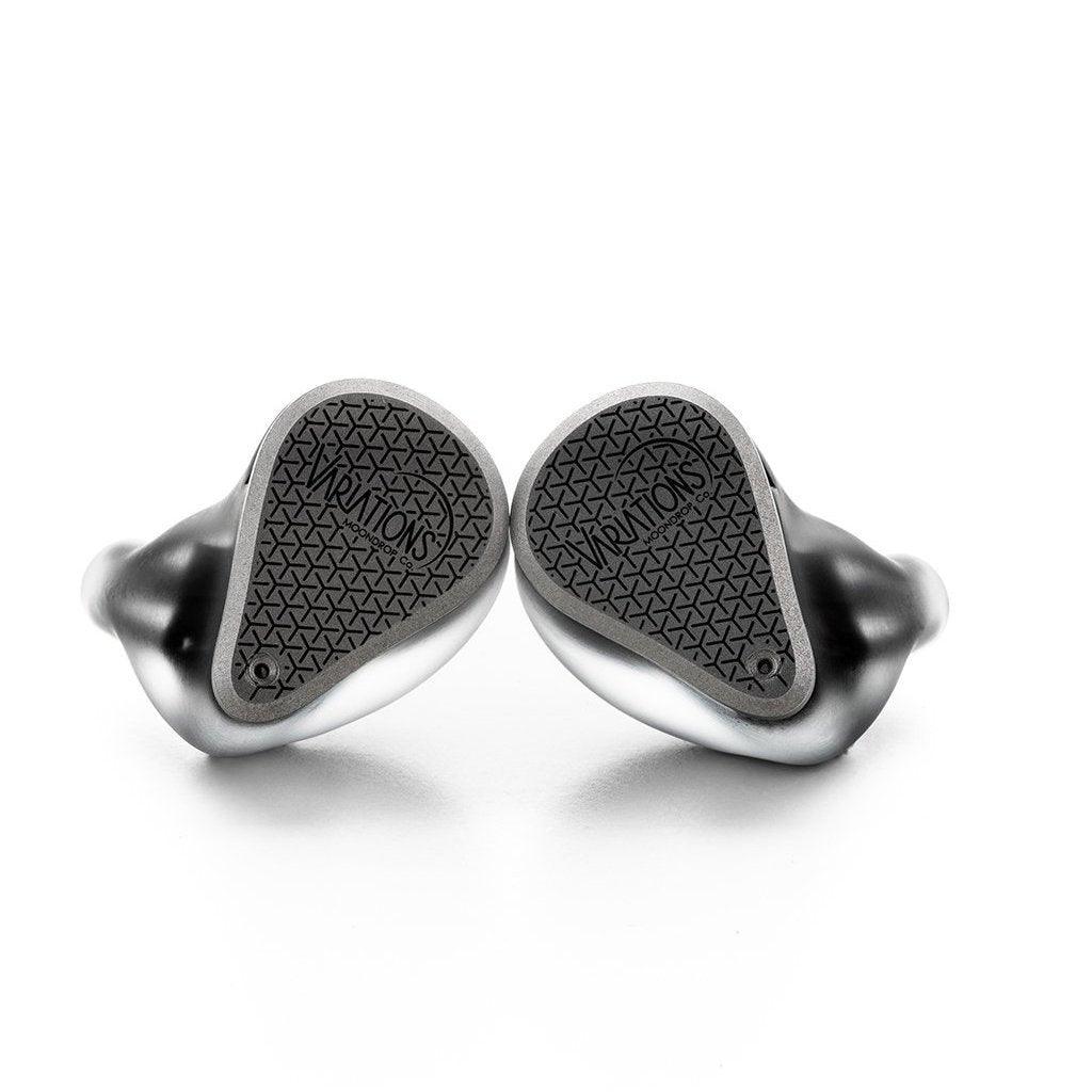 A pair of silver and black Moondrop Variations Tribrid In-Ear Headphones, featuring wireless design and textured backs with the Moondrop brand name visible, are displayed against a white background.